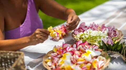 A woman making leis on Kauai